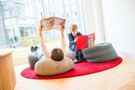 Kinder in der gemütlich eingerichteten Leseecke im Quartiershaus "Middenmang"
