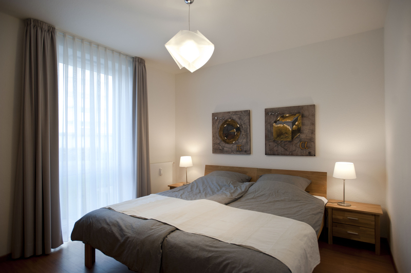 Schlafzimmer mit Doppelbett und Nachttischen aus Holz.